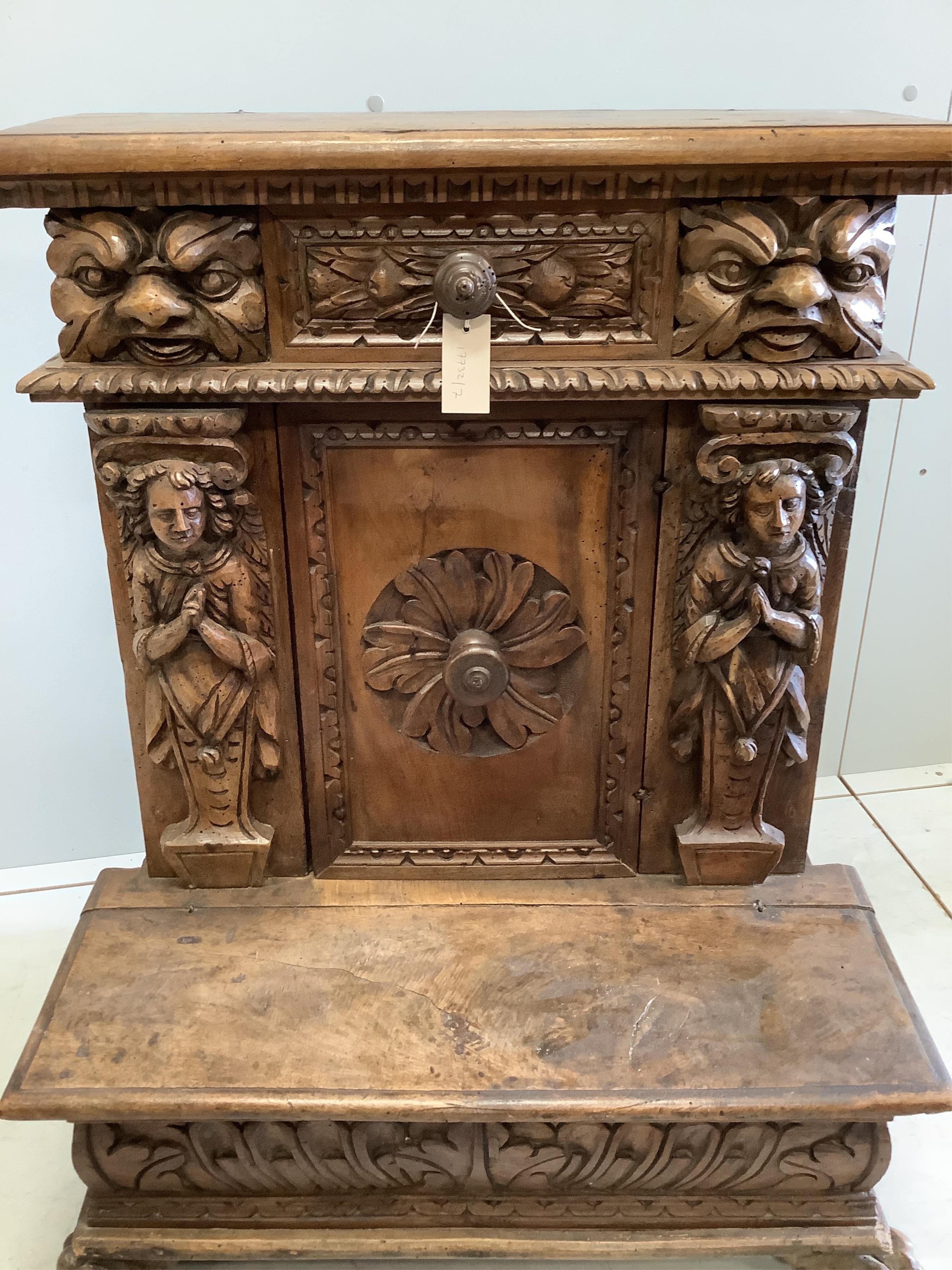 An 18th century style Continental carved walnut prie dieu cabinet, width 72cm, depth 49cm, height 90cm. Condition - poor to fair